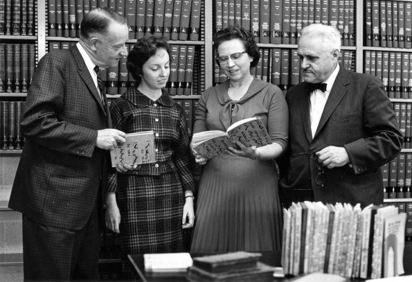 [Floyd Rittenhouse, Jamie Trefz, Mary Jane Mitchell, and Daniel Walther looking at the Martin Luther Collection acquired by the James White Library]