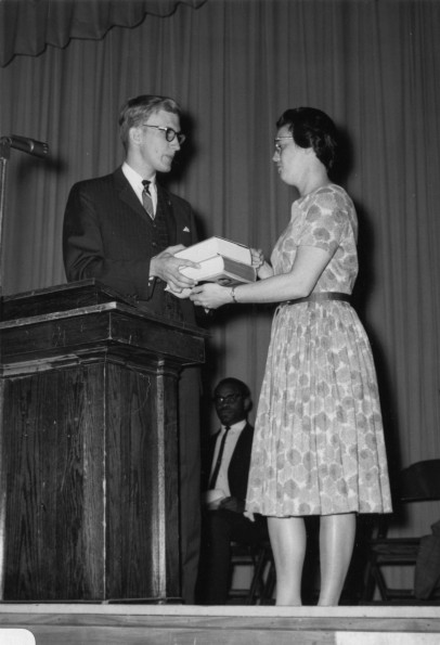 [Merlene Ogden, professor of English at Andrews University, receives the first student association 'Professor of the Year' award from Carlos Schwantes, committee chairman.]