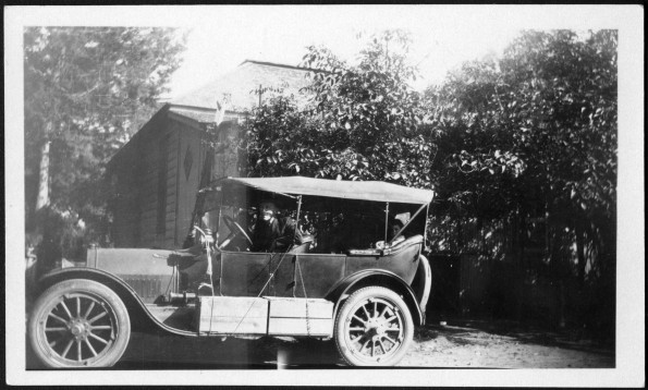 [Uriah Wilton Smith in his Ford Model T Touring car with others, probably preparing to leave on a journey]