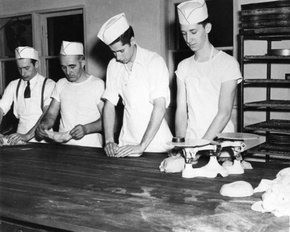 [Unknown men preparing food at Emmanuel Missionary College]