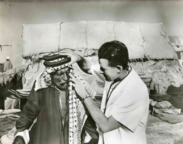 [Unknown doctor aiding a man in an unknown country]