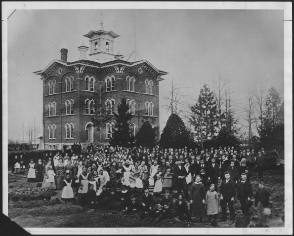 Battle Creek College students and staff with building in the rear
