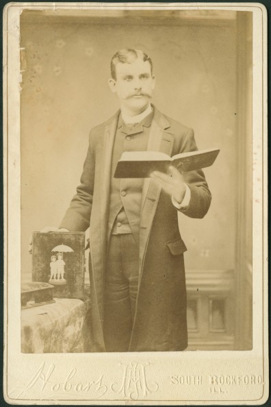 William Ward Simpson posing with a songbook